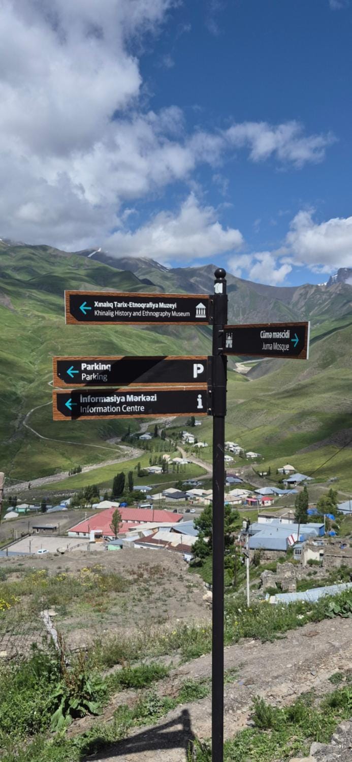 Nearby landmark, Day, Natural landscape, Logo/Certificate/Sign, Text overlay, Mountain view, Street view