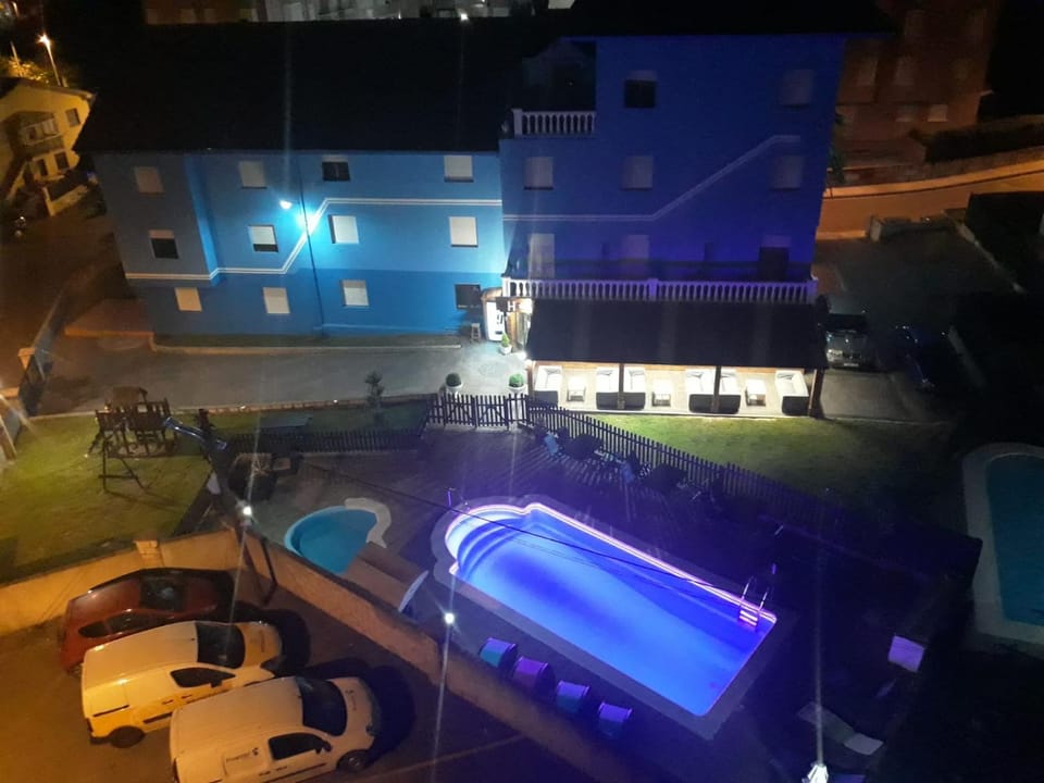 Property building, Patio, Night, Natural landscape, Pool view, Swimming pool, sunbed