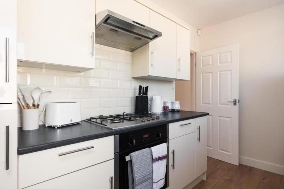 Kitchen or kitchenette, dishwasher, oven, stove, toaster