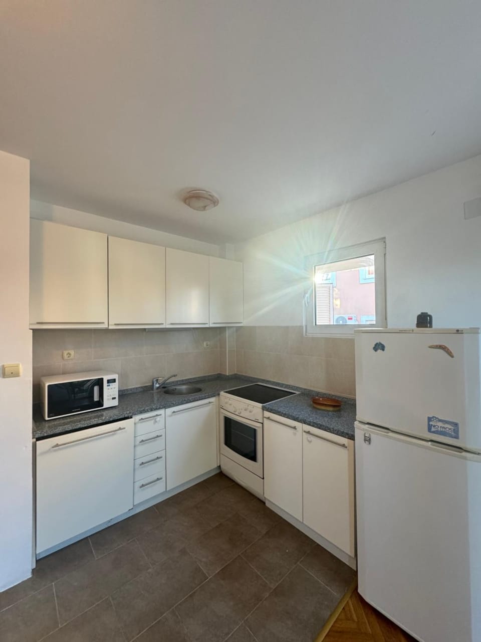 Kitchen or kitchenette, dishwasher, oven, stove