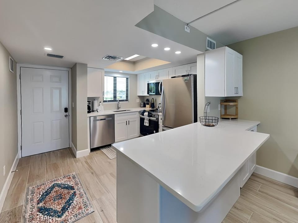 Kitchen or kitchenette, dishwasher, furniture, microwave, oven, stove, kitchen, air conditioner