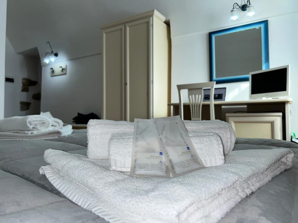 Bed, TV and multimedia, Seating area, Bedroom, towels, wardrobe