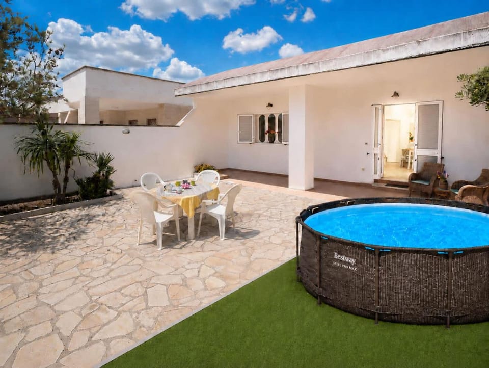Property building, Patio, Day, Living room, Seating area, Dining area, Pool view, Swimming pool, sunbed