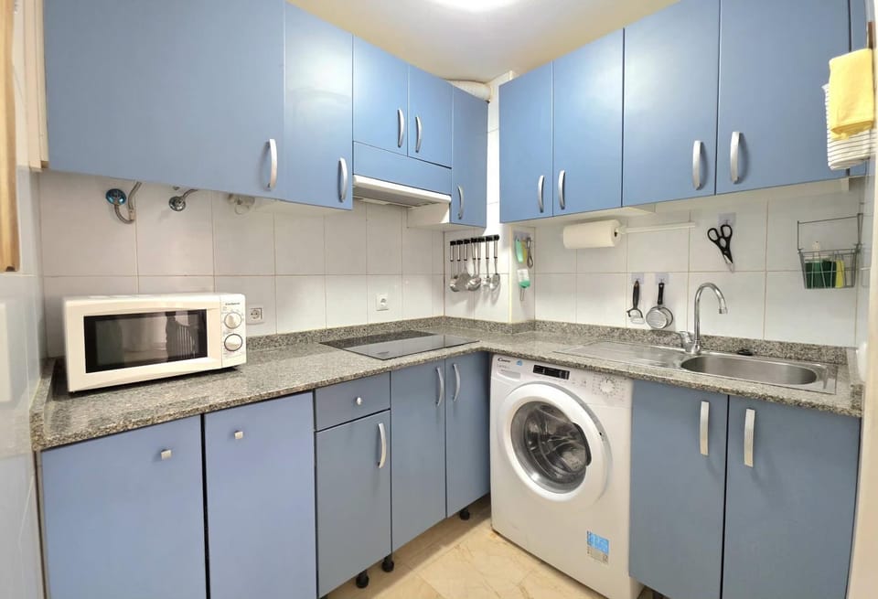 Kitchen or kitchenette, microwave, stove, washing machine