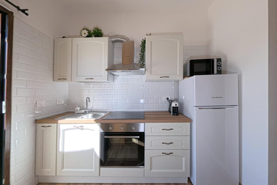 Kitchen or kitchenette, microwave, oven, stove, air conditioner
