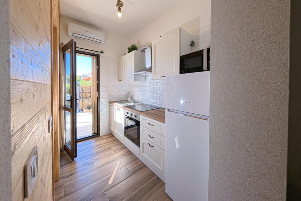 Kitchen or kitchenette, microwave, oven, stove, air conditioner