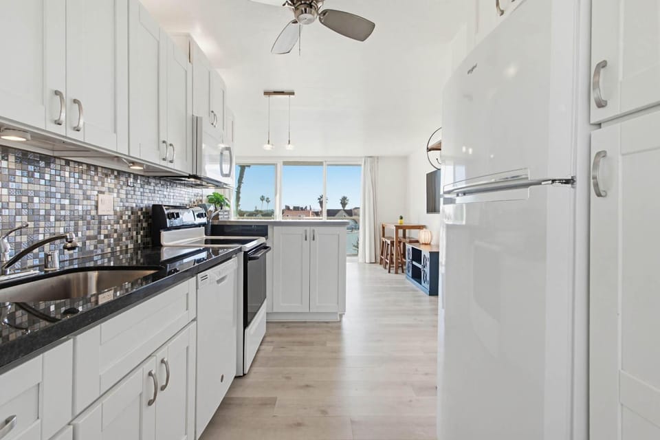 Kitchen or kitchenette, dishwasher, oven, stove