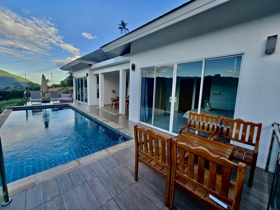 Property building, Patio, Natural landscape, Pool view, Swimming pool, sunbed