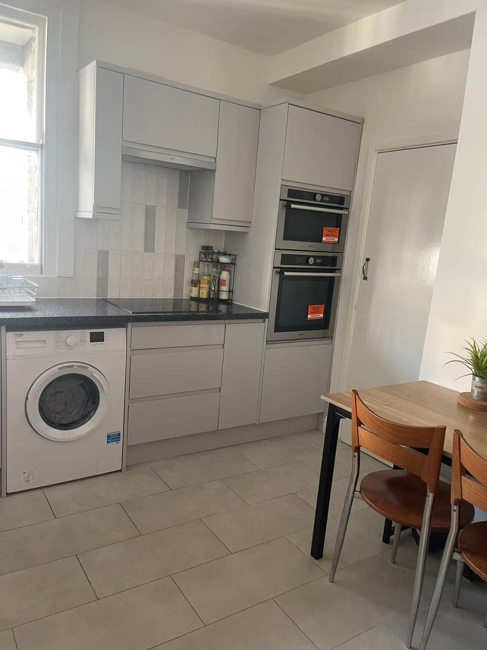 Kitchen or kitchenette, microwave, oven, stove, washing machine, kitchen