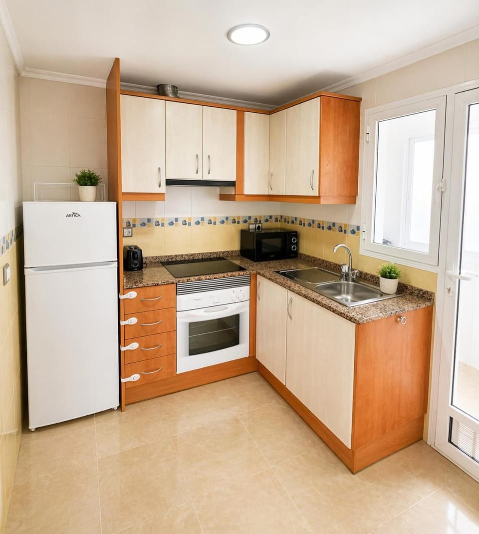 Kitchen or kitchenette, microwave, oven, stove, toaster