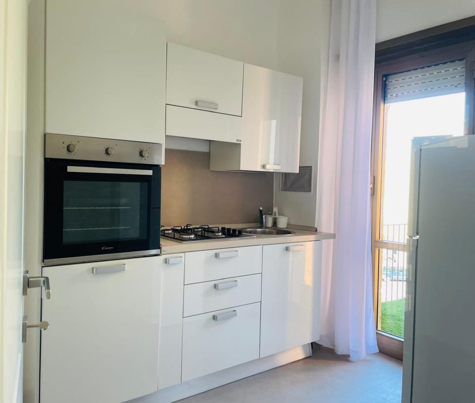 Kitchen or kitchenette, dishwasher, oven, stove