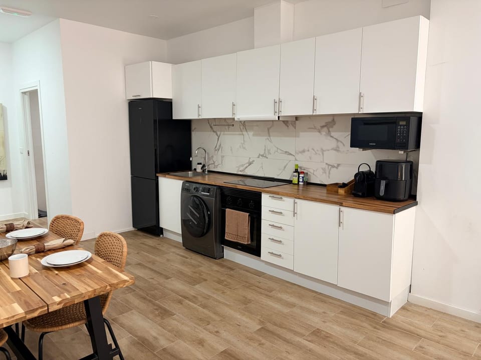 Kitchen or kitchenette, microwave, oven, stove, washing machine, kitchen