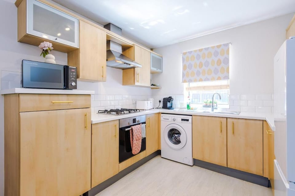 Kitchen or kitchenette, dishwasher, oven, stove, toaster, washing machine