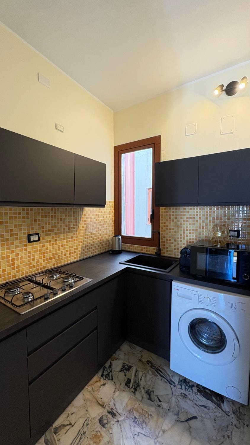 Kitchen or kitchenette, oven, stove, washing machine