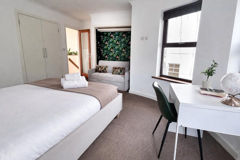 Bed, Bathroom, Photo of the whole room, Decorative detail, Seating area, Bedroom, Bath, flat iron, hair dryier, towels, wardrobe