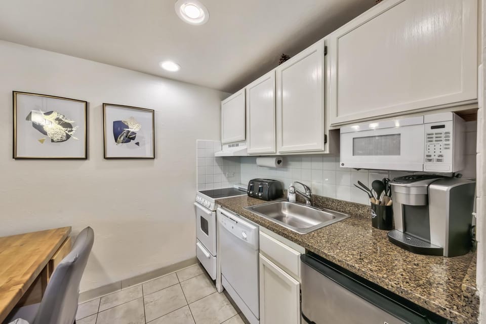 Kitchen or kitchenette, dishwasher, furniture, microwave, stove, toaster