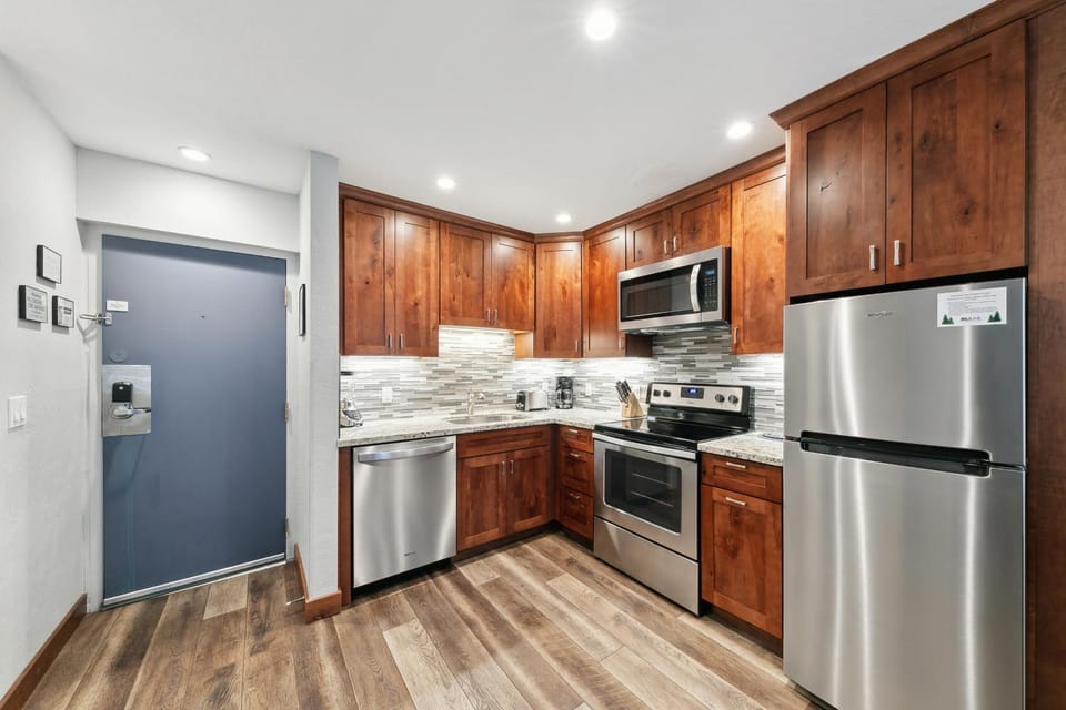 Kitchen or kitchenette, dishwasher, furniture, microwave, oven, stove, kitchen