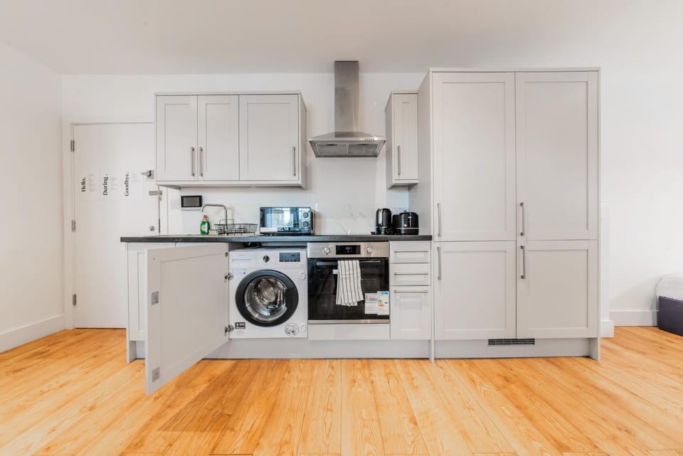 Kitchen or kitchenette, microwave, oven, stove, washing machine