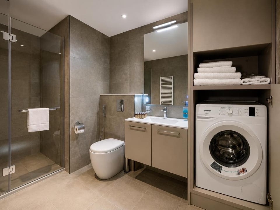 Shower, Toilet, Bathroom, towels, washing machine, dryer