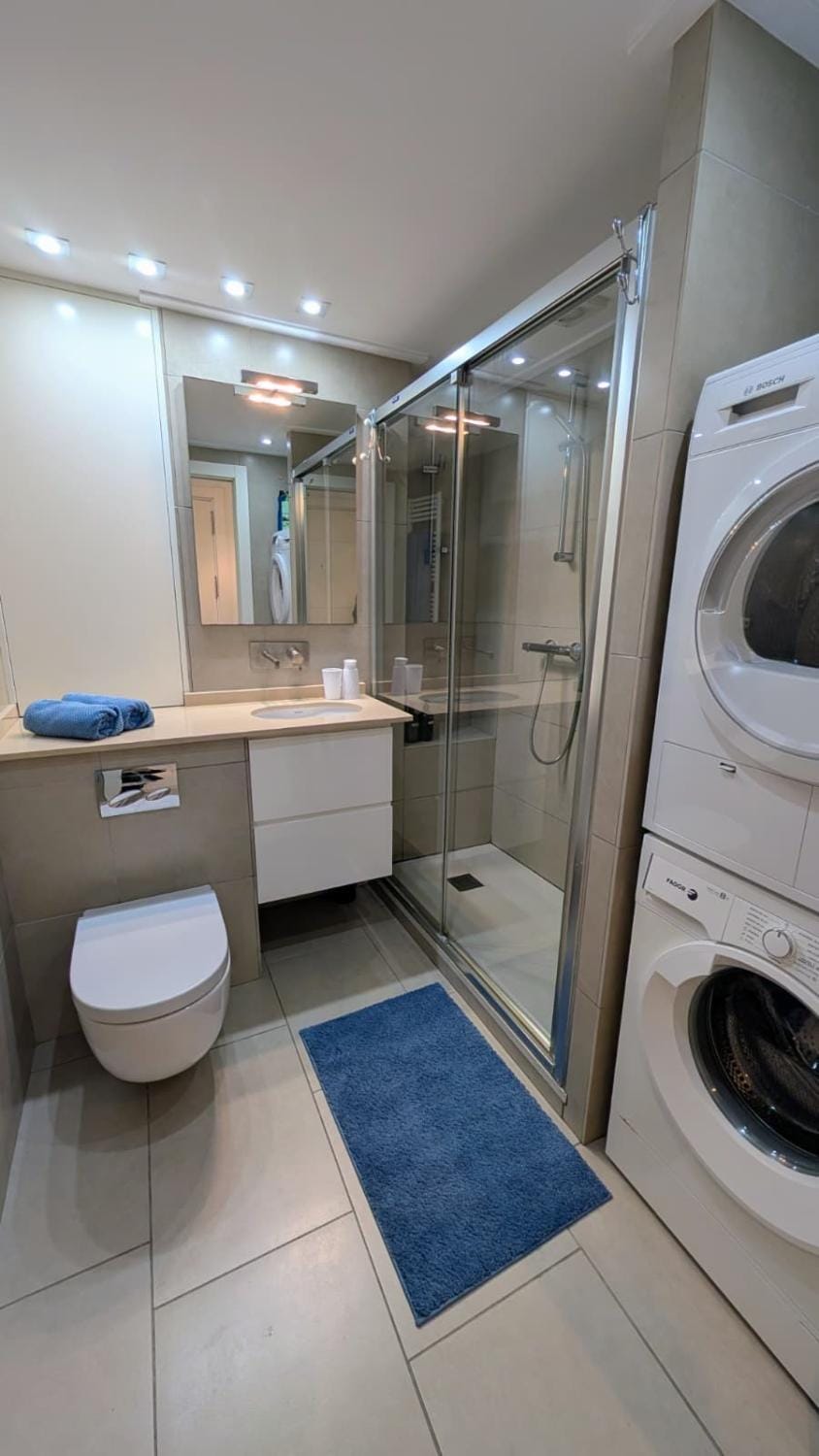 Shower, Toilet, Bathroom, towels, washing machine, dryer