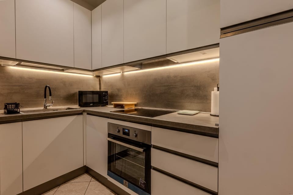 Kitchen or kitchenette, dishwasher, oven, stove