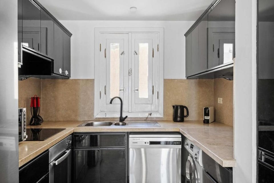 Kitchen or kitchenette, dishwasher, oven, stove