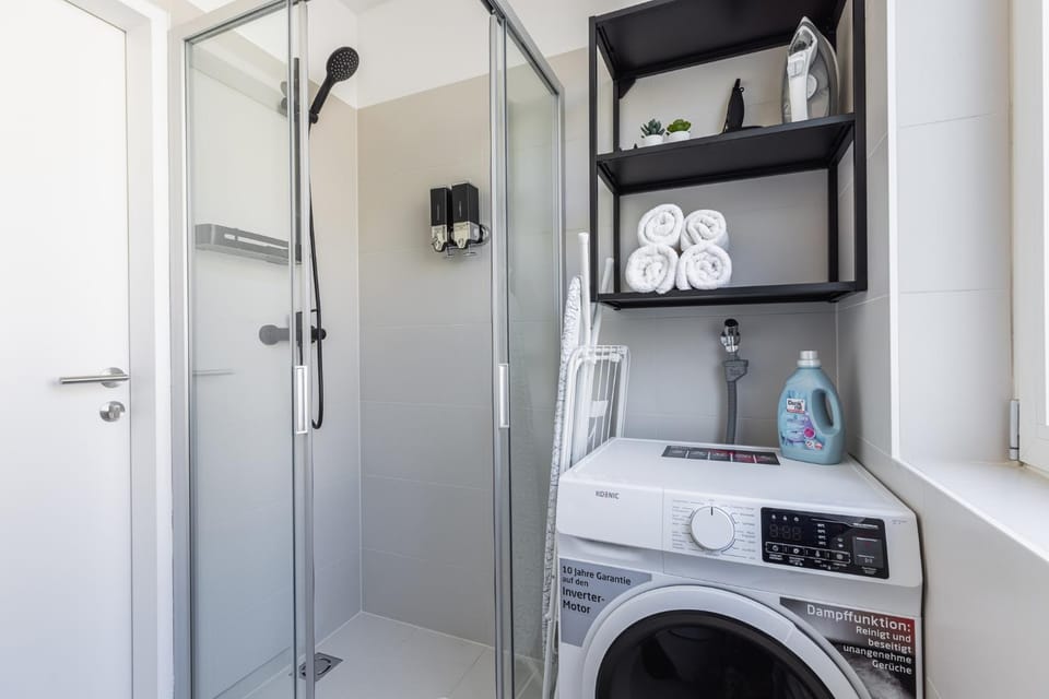 Shower, Bathroom, flat iron, hair dryier, towels, washing machine, dryer