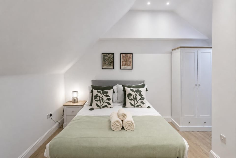 Bed, Bathroom, Photo of the whole room, Decorative detail, Bedroom, flat iron, hair dryier, towels, wardrobe