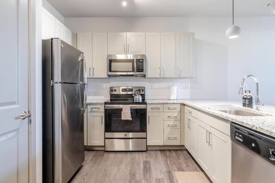 Kitchen or kitchenette, dishwasher, oven, stove