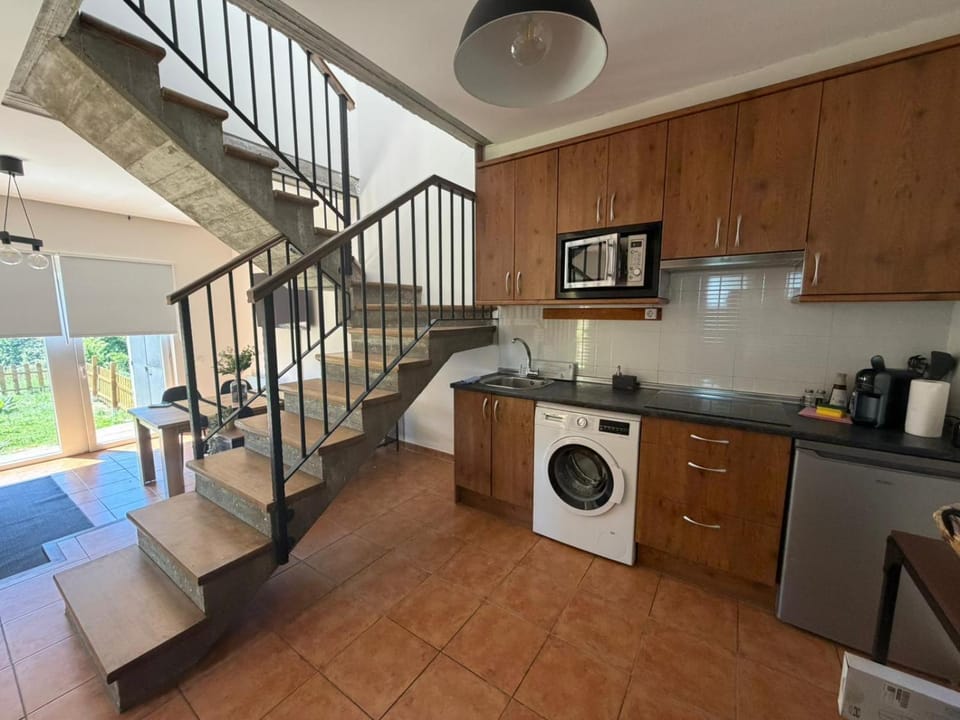 Photo of the whole room, microwave, stove, washing machine