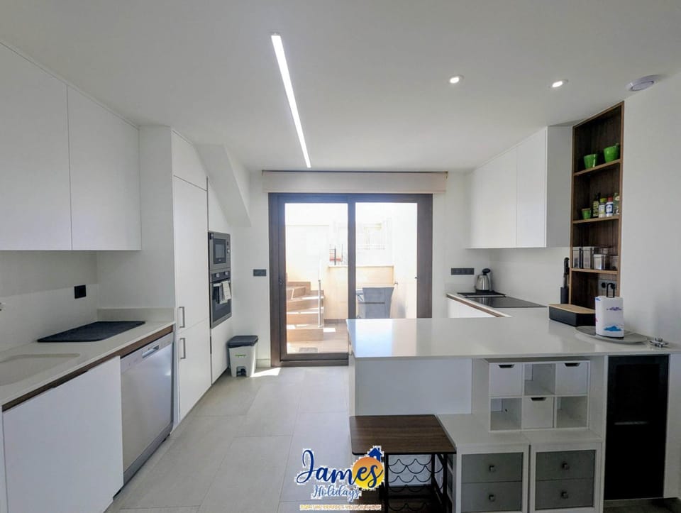 Kitchen or kitchenette, dishwasher, oven, stove