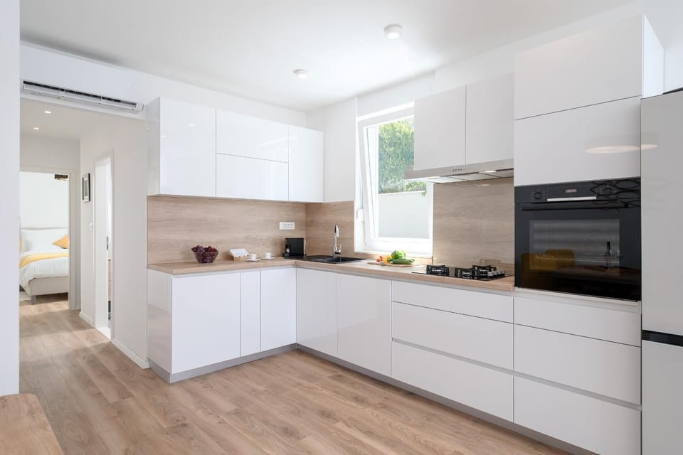 Kitchen or kitchenette, dishwasher, oven, stove