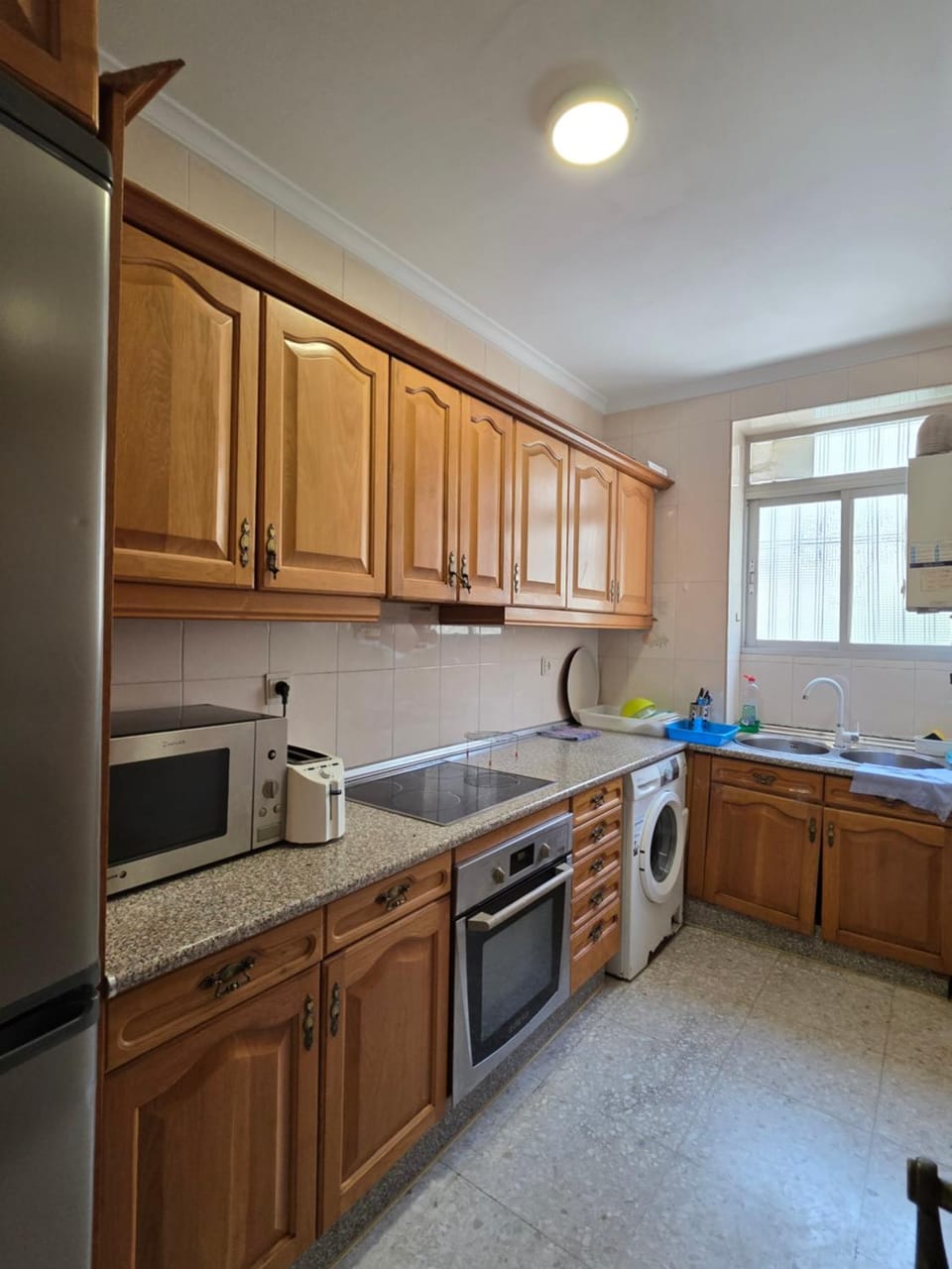 Kitchen or kitchenette, oven, stove, toaster, washing machine