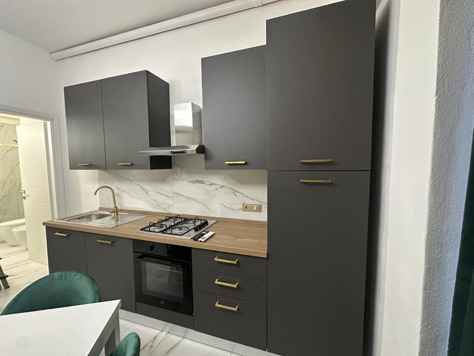 Kitchen or kitchenette, oven, stove, wardrobe, laundry, washing machine, dryer