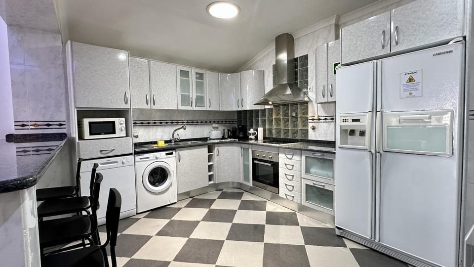 Kitchen or kitchenette, oven, stove, washing machine