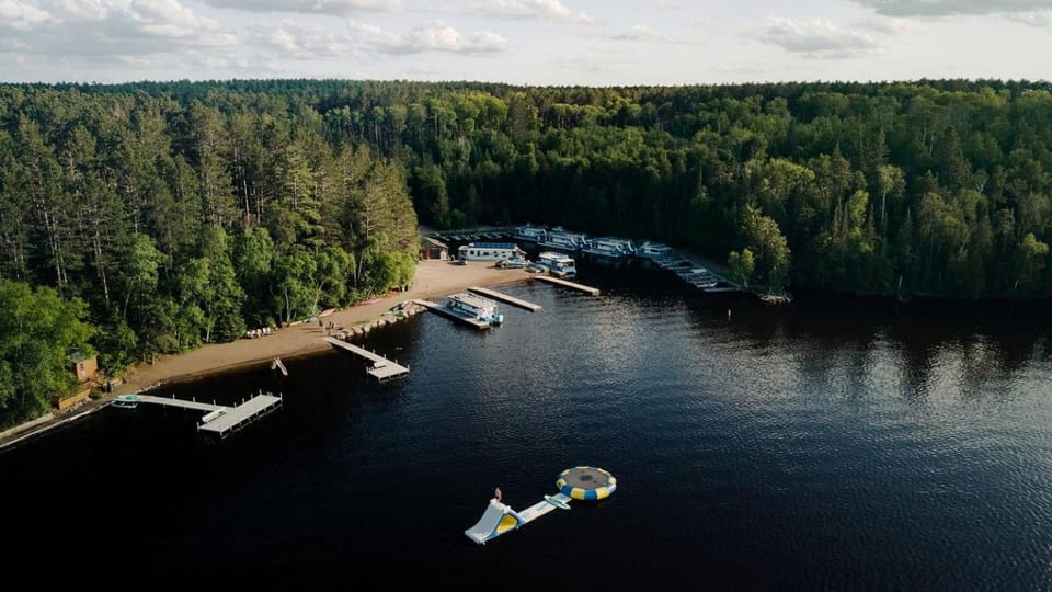 Spacious Sportsman Houseboat with Water Slide Near Babbitt, MN – Perfect for Fishing Adventures and Group Getaways Docked boat in Minnesota
