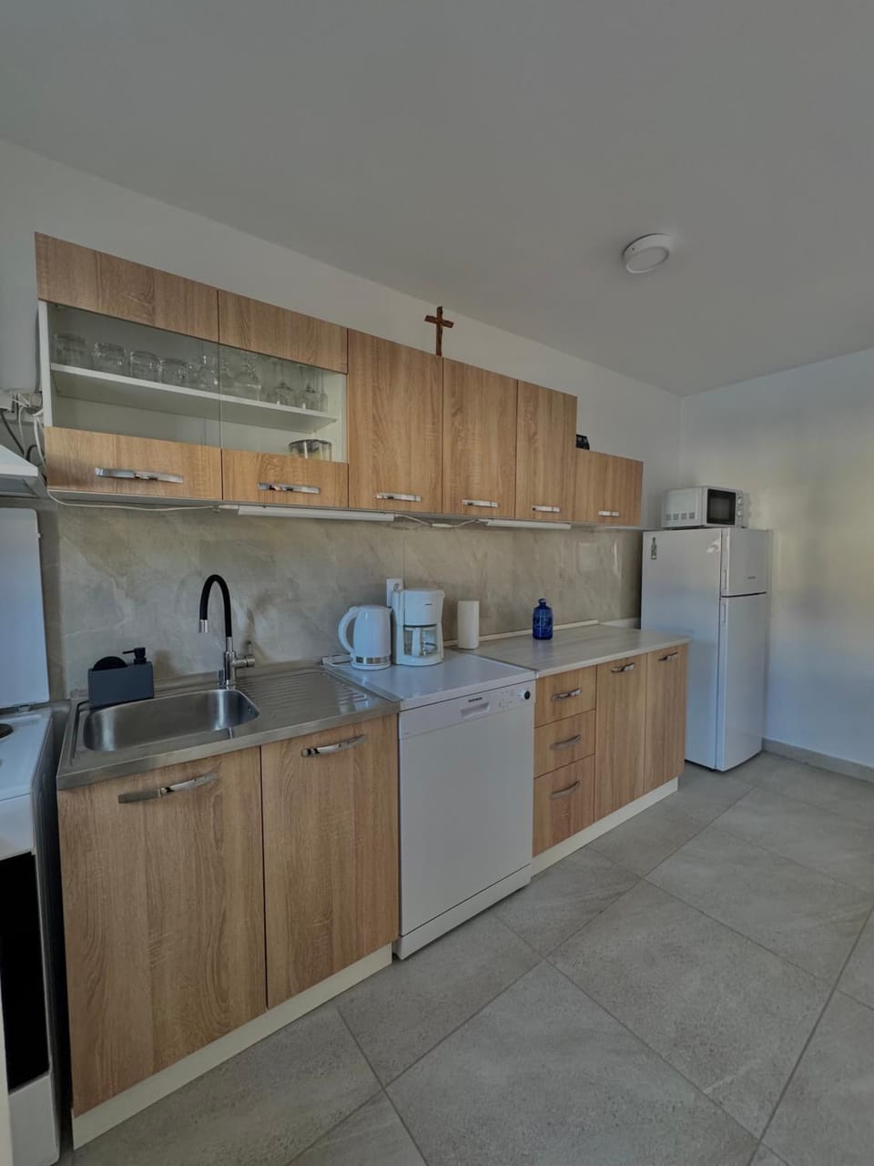 Kitchen or kitchenette, dishwasher, microwave, oven, stove