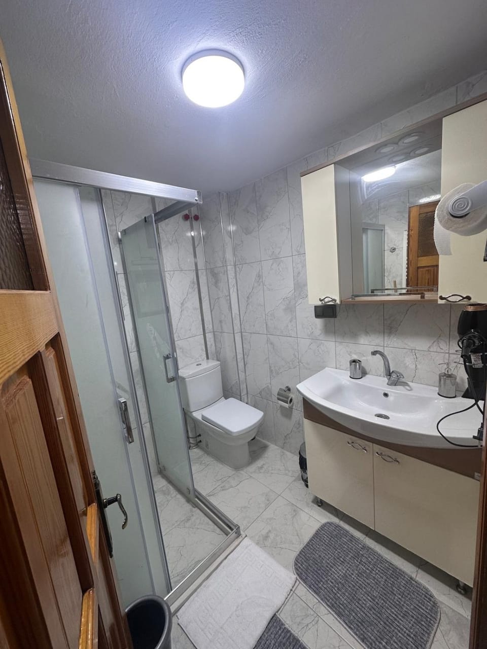Shower, Toilet, Bathroom, hair dryier, towels