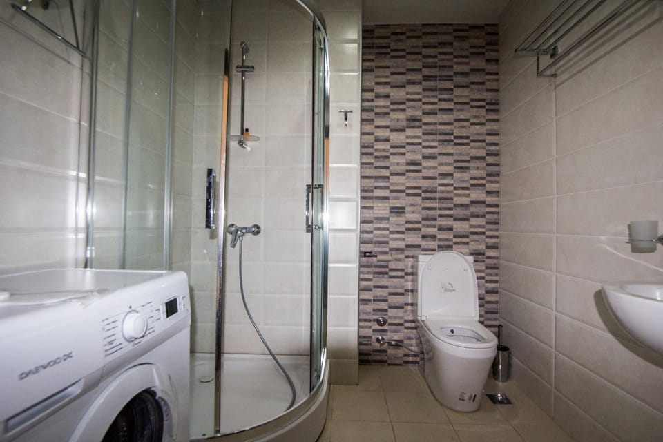 Shower, Toilet, Bathroom, towels, washing machine, dryer