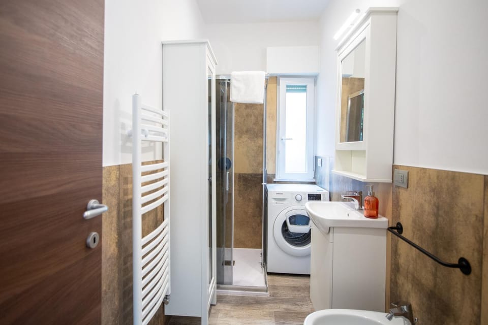 Shower, Toilet, Bathroom, bidet, towels, washing machine, dryer