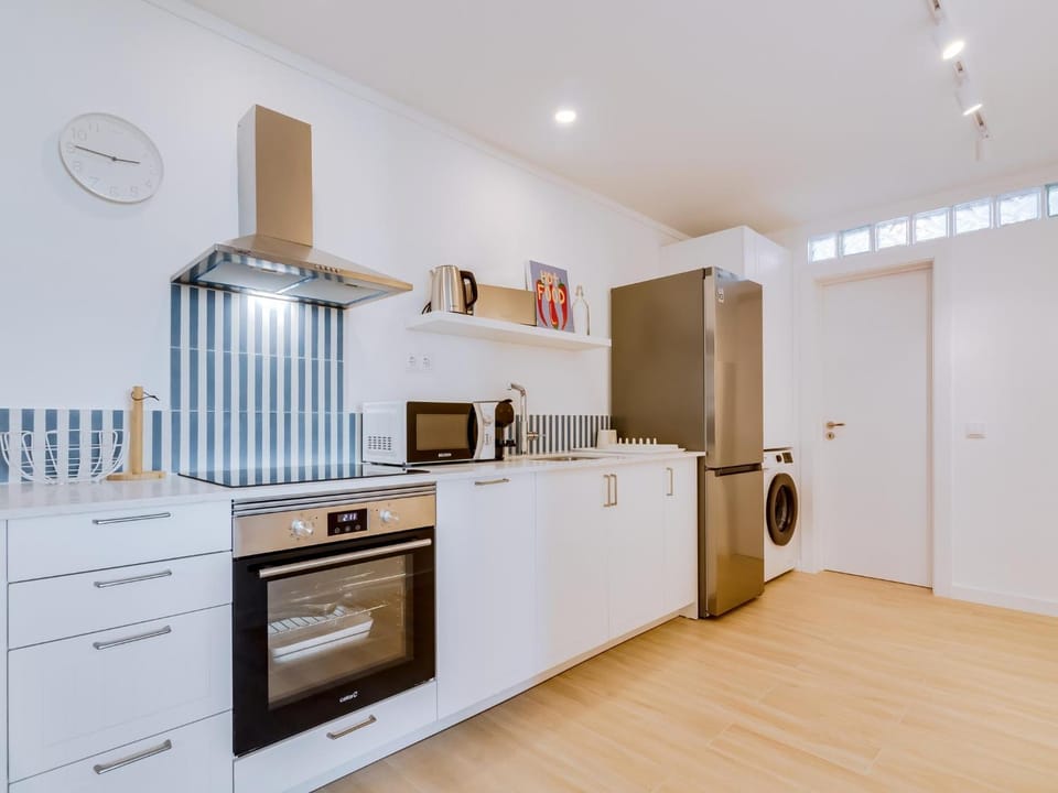 Kitchen or kitchenette, dishwasher, oven, stove, toaster, washing machine