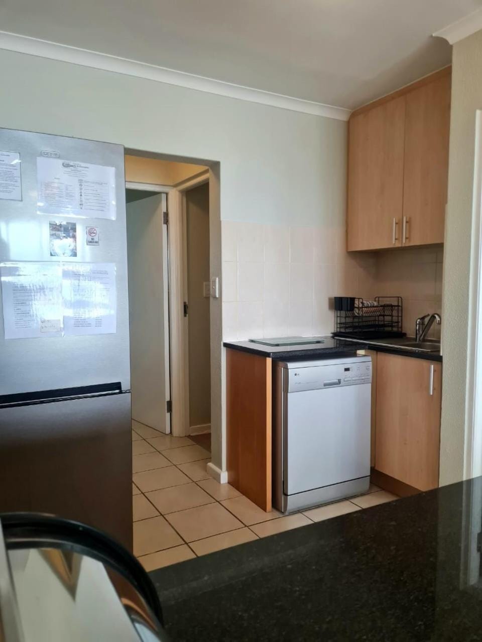 Kitchen or kitchenette, dishwasher, oven, stove