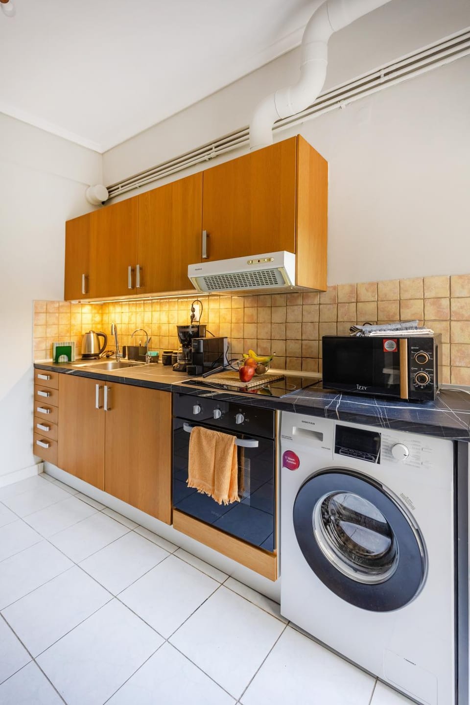 Kitchen or kitchenette, oven, stove, washing machine