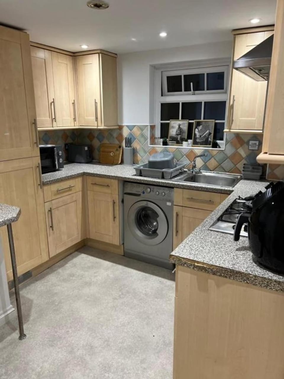 Kitchen or kitchenette, microwave, oven, stove, toaster, washing machine