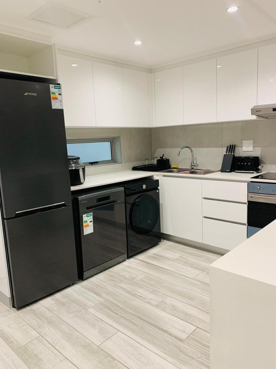 Kitchen or kitchenette, dishwasher, oven, stove