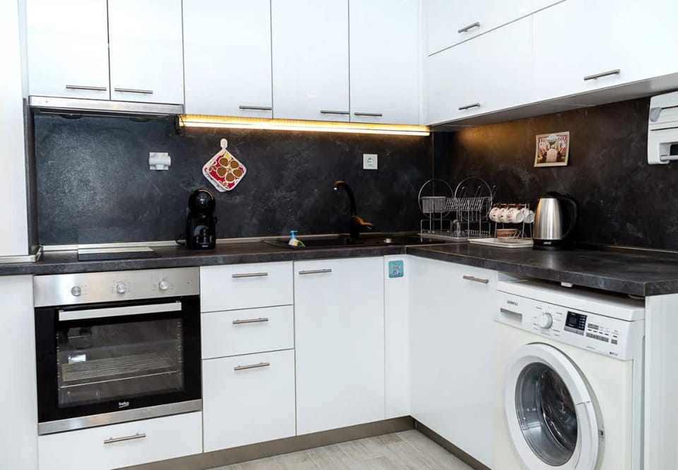 Kitchen or kitchenette, stove, washing machine