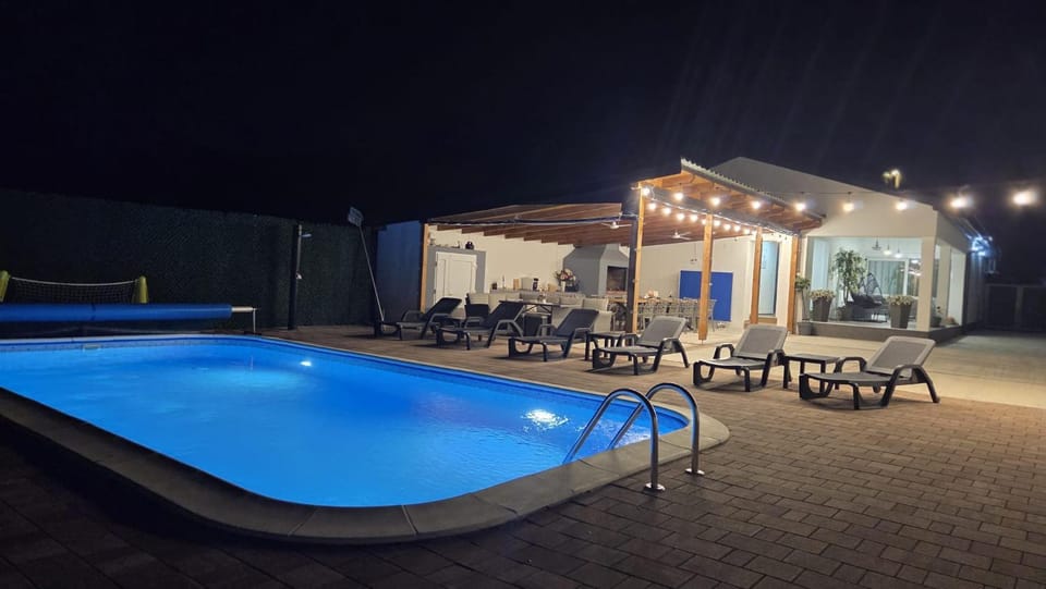 Patio, Night, Pool view, Swimming pool, sunbed