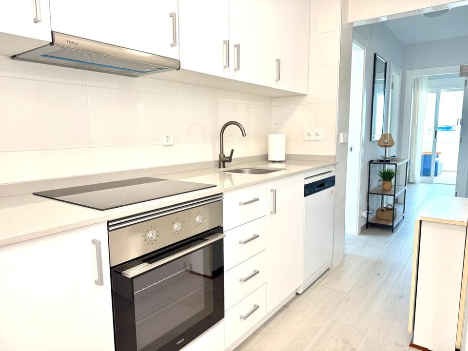 Kitchen or kitchenette, dishwasher, oven, stove