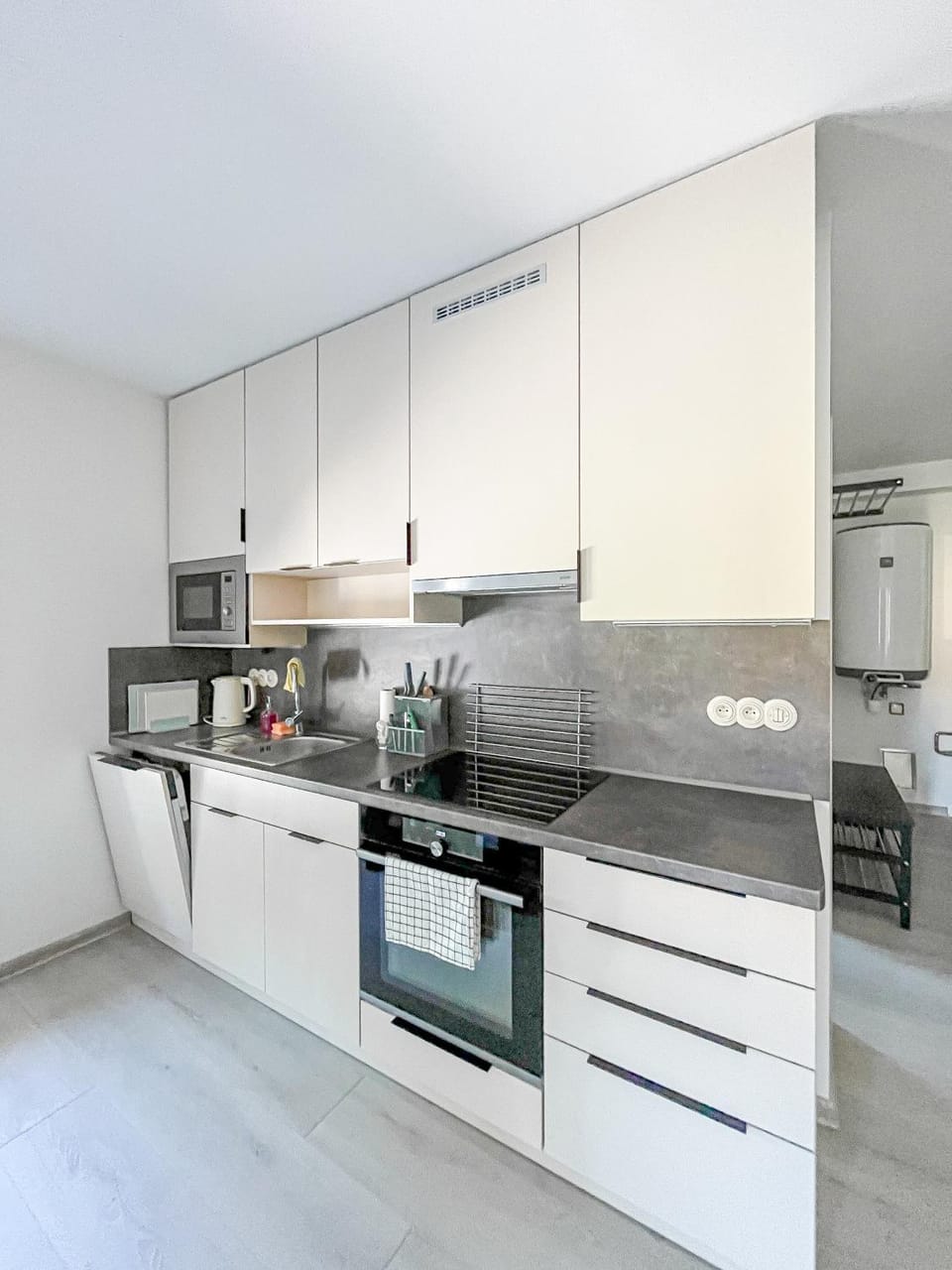 Kitchen or kitchenette, dishwasher, oven, stove
