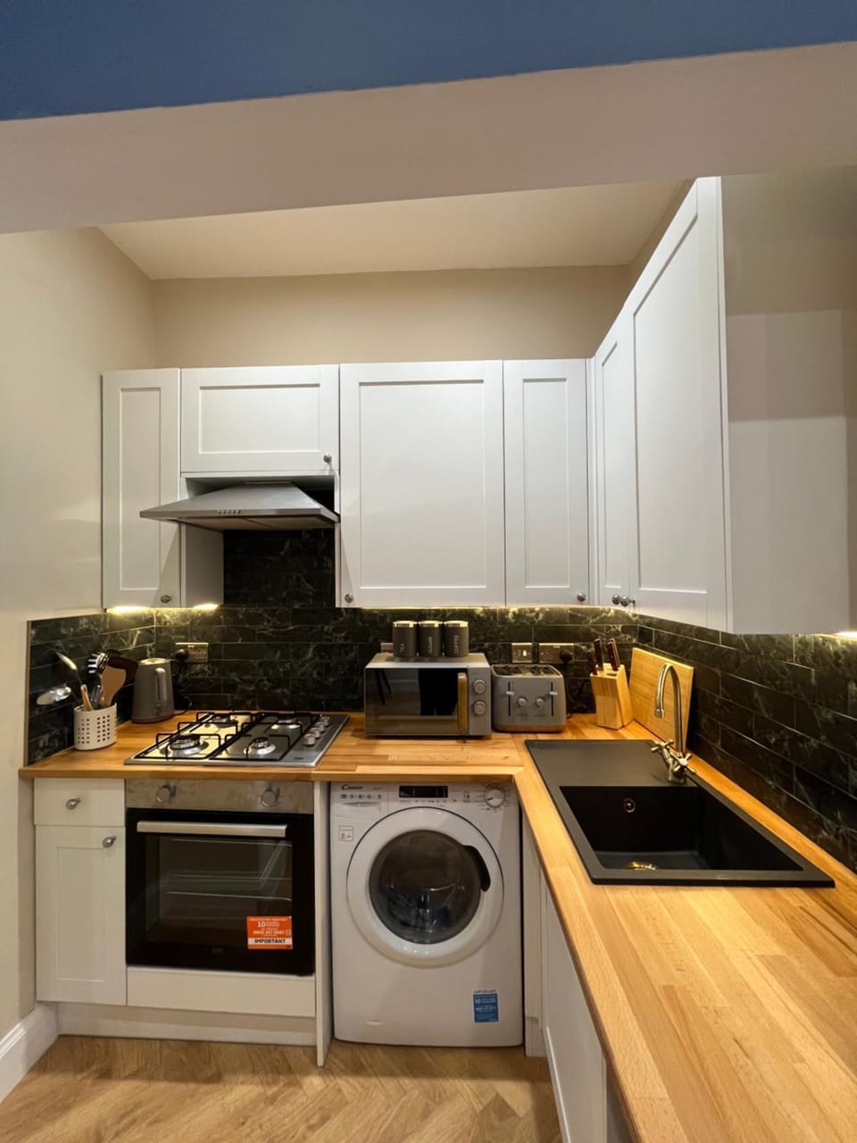 Kitchen or kitchenette, stove, toaster, washing machine
